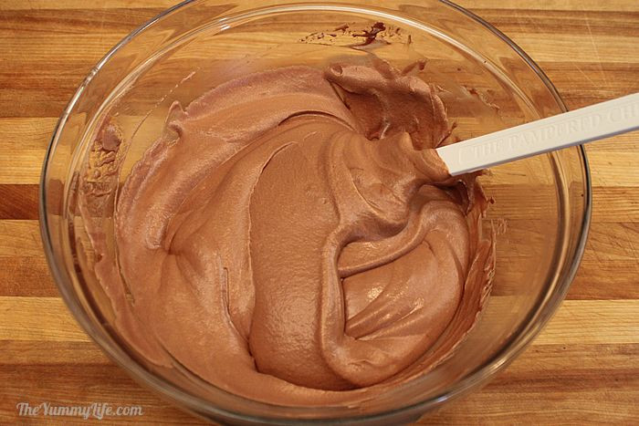 Folding remaining whipped cream into the chocolate mixture with a spatula