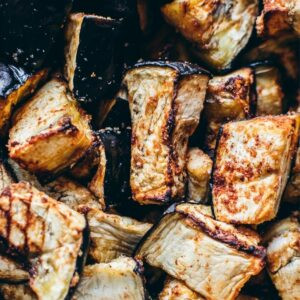 Close-up of seasoned air fryer eggplant cubes with a slightly crispy and golden-brown exterior.