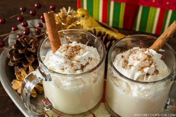 Warm and inviting eggnog served hot in glass mugs, perfect for a cold evening, a delicious holiday beverage.