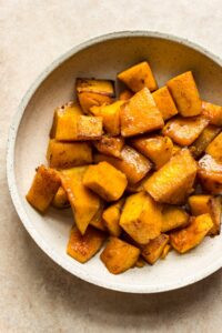 Golden brown honey-roasted butternut squash cubes, highlighting their caramelized edges and tender interior.