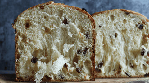 Close-up of panettone slices served with double cream, showcasing a classic way to serve panettone.