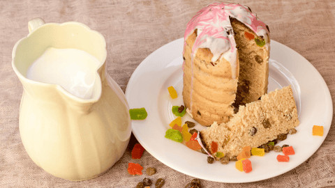 Panettone pieces being dipped into Italian hot chocolate, illustrating a fun serving suggestion for panettone.