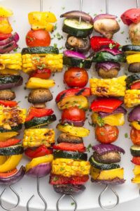 Colorful grilled vegetable kabobs with bell peppers, zucchini, and onions, displaying their vibrant colors and grill marks.