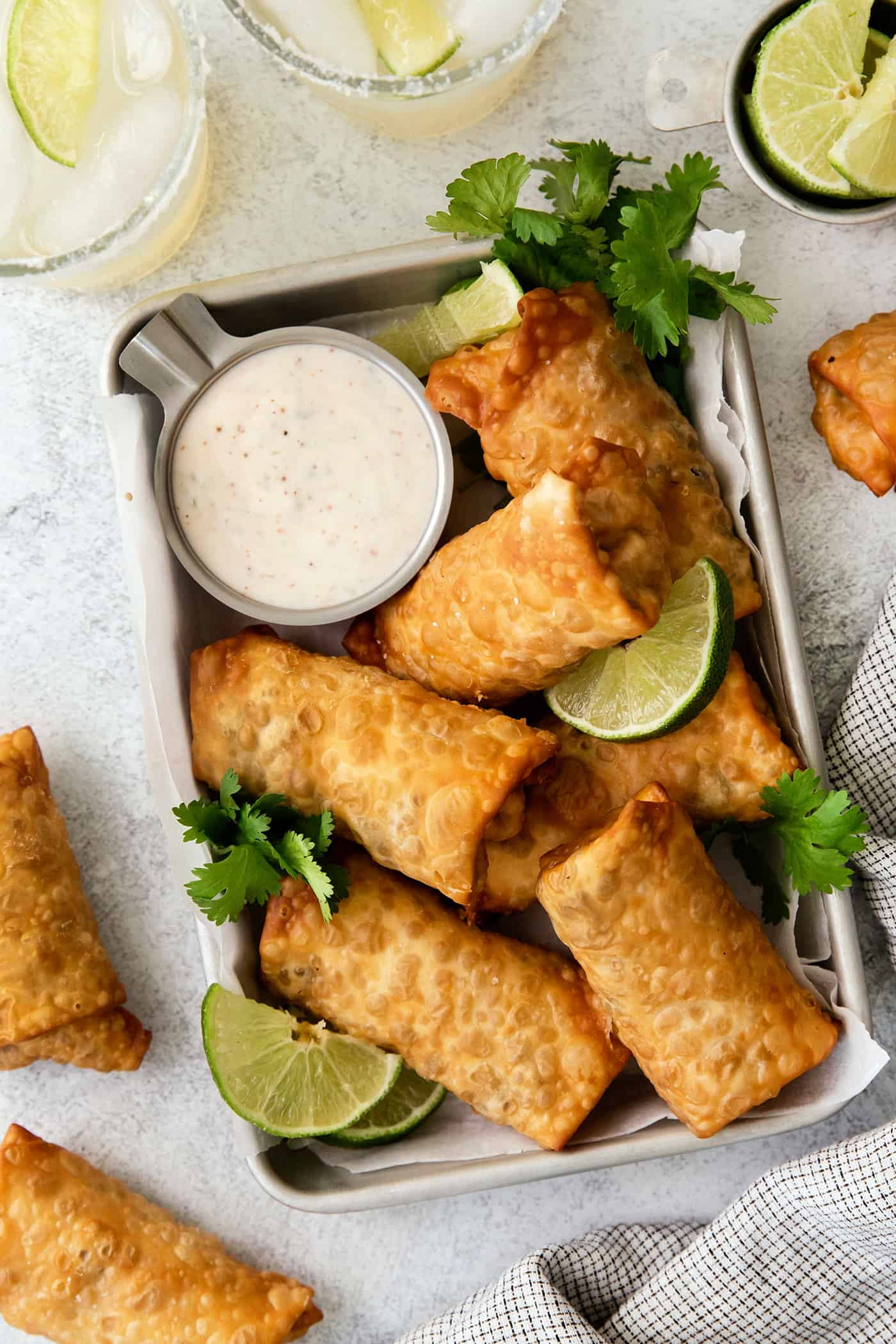 Overhead view of southwest egg rolls on a tray, showcasing the presentation and accompaniments